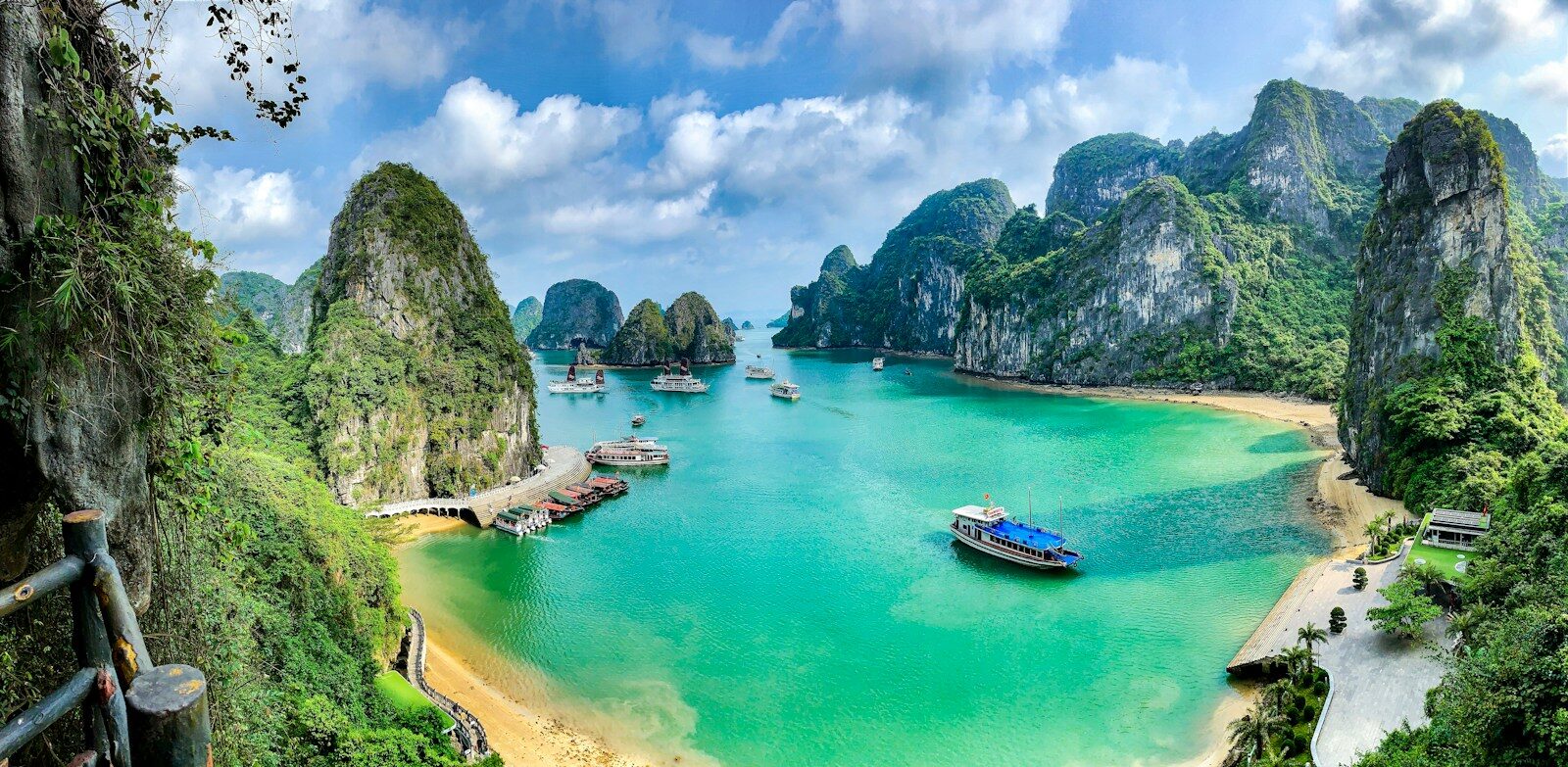 Boats on the turquoise water of Ha Long Bay surrounded by limestone karst islands, Vietnam
